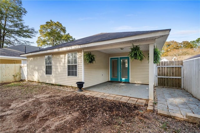 back of property with a patio area and fence