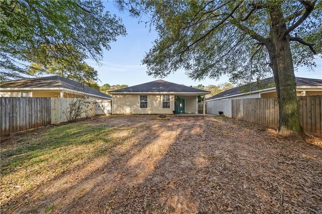 rear view of property with a fenced backyard