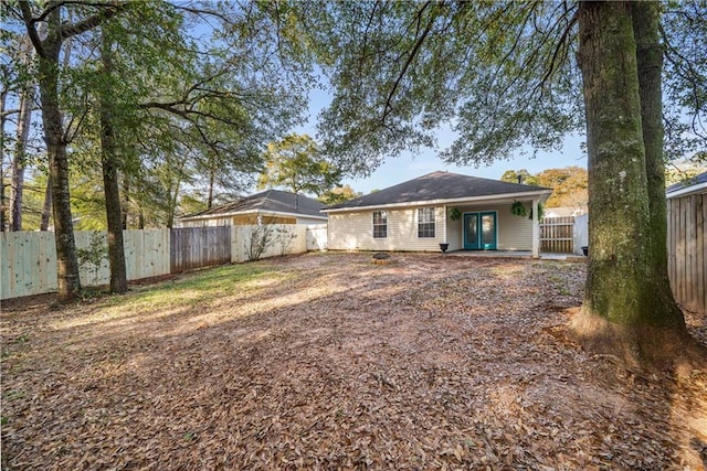 back of property featuring a fenced backyard