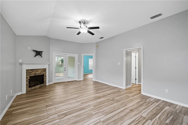 unfurnished living room featuring a ceiling fan, visible vents, and light wood finished floors