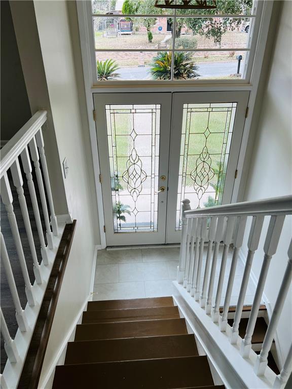 interior space with french doors and tile patterned floors