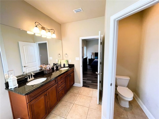 bathroom with tile patterned floors, vanity, and toilet