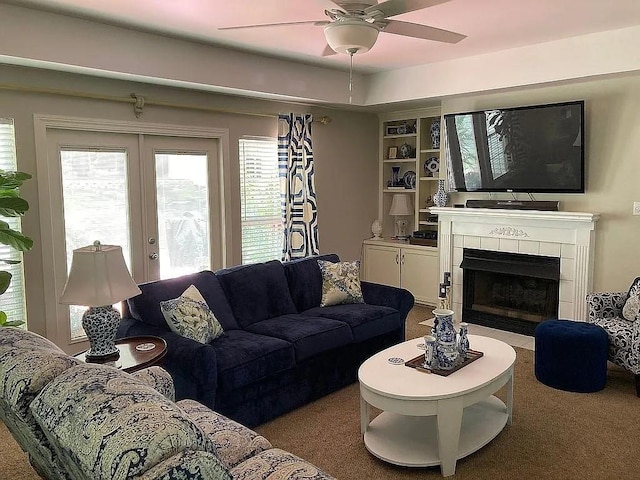 living area with french doors, carpet, ceiling fan, and a fireplace