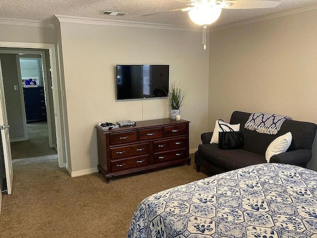 bedroom featuring visible vents, baseboards, ornamental molding, carpet flooring, and a textured ceiling