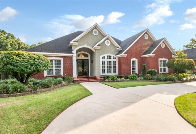 view of front of property with a front yard and french doors