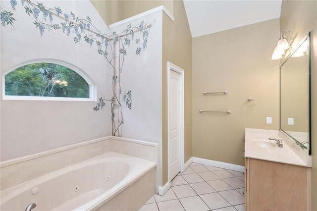 bathroom with vanity, lofted ceiling, a bathing tub, and tile patterned floors