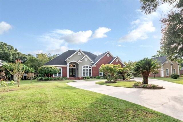 view of front of home with a front yard and a garage