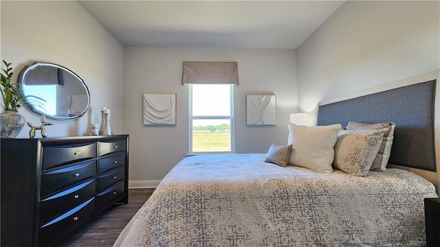 bedroom with dark wood-style floors and baseboards