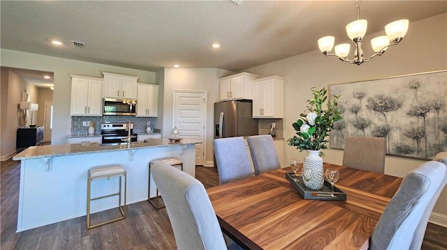 dining room with recessed lighting, visible vents, a notable chandelier, and dark wood-style floors