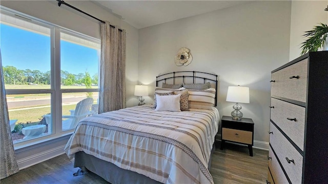 bedroom with wood finished floors and baseboards