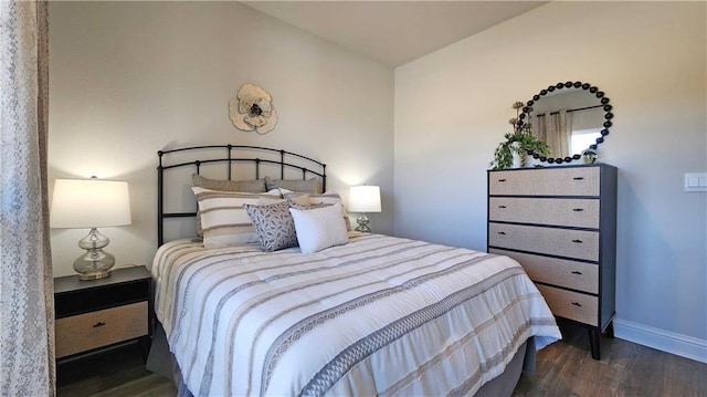 bedroom with baseboards and dark wood-style flooring