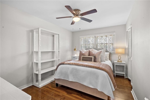 bedroom with a closet, baseboards, a ceiling fan, and wood finished floors
