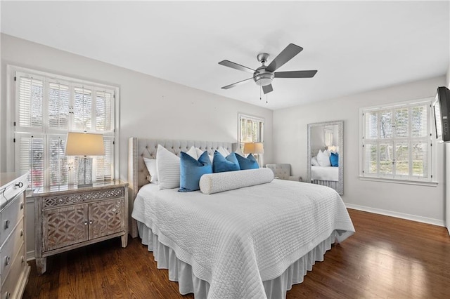 bedroom featuring baseboards, a ceiling fan, and dark wood-style floors