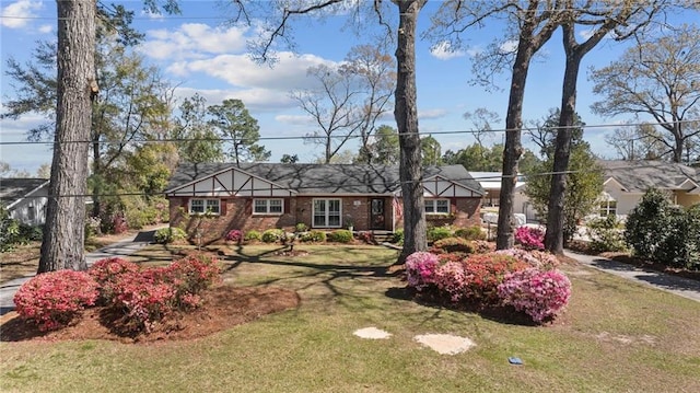 view of front of home with a front yard and brick siding