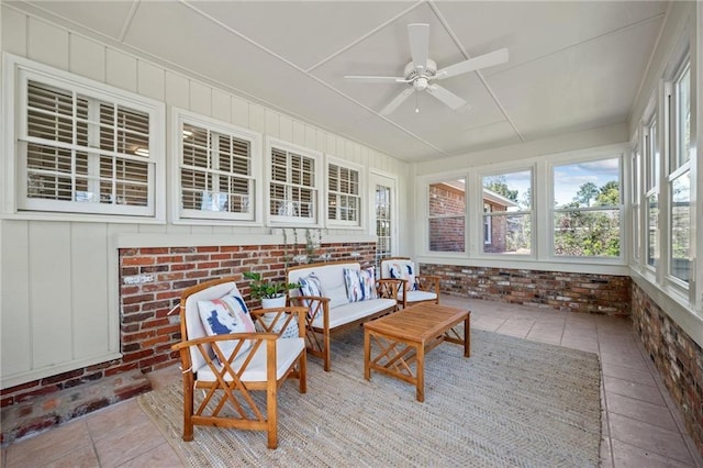 sunroom with tile patterned flooring and brick wall