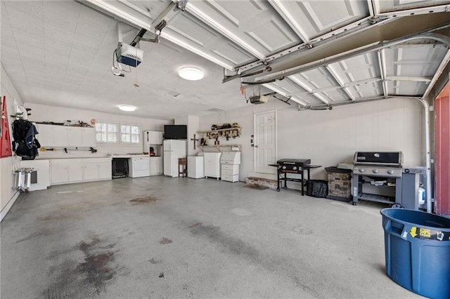 garage featuring a garage door opener and freestanding refrigerator