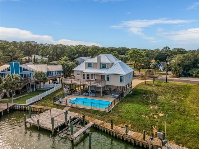 rear view of property with a balcony, a water view, and a patio