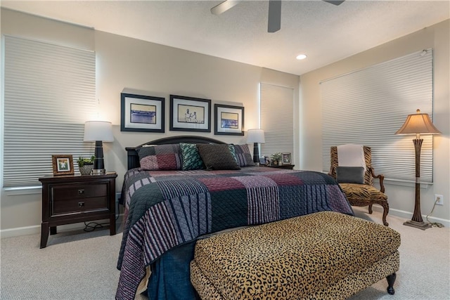 bedroom with ceiling fan and light colored carpet