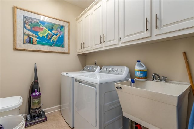 laundry room with cabinets, sink, and washer and dryer