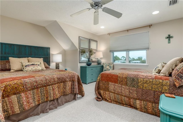 bedroom with a textured ceiling, ceiling fan, carpet, and lofted ceiling