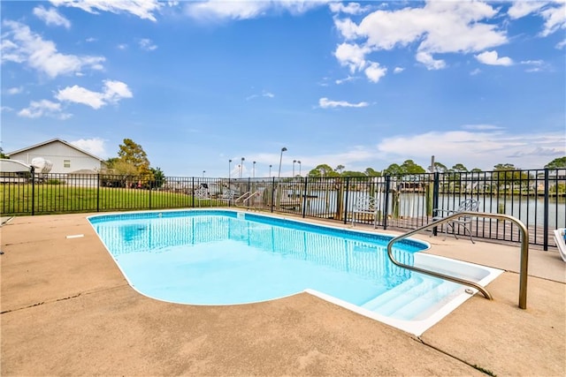 view of swimming pool featuring a patio area and a water view