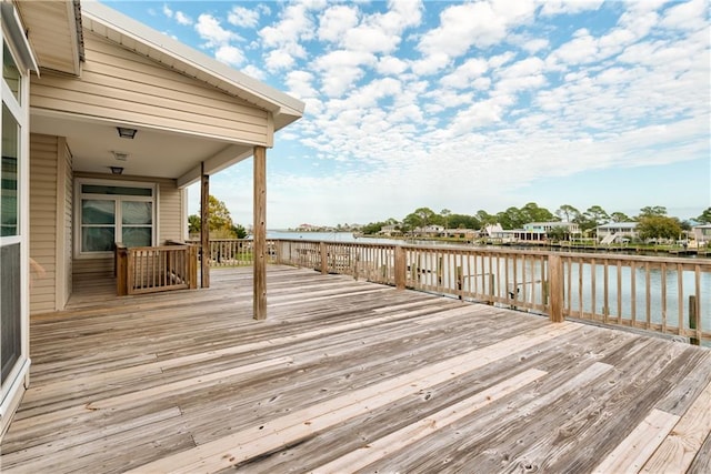 wooden terrace featuring a water view