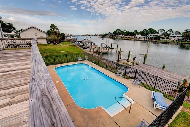 view of pool with a water view and a boat dock