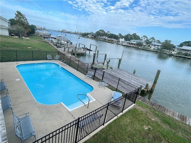 view of swimming pool with a water view and a dock