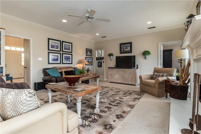 living room with crown molding, ceiling fan, and light colored carpet