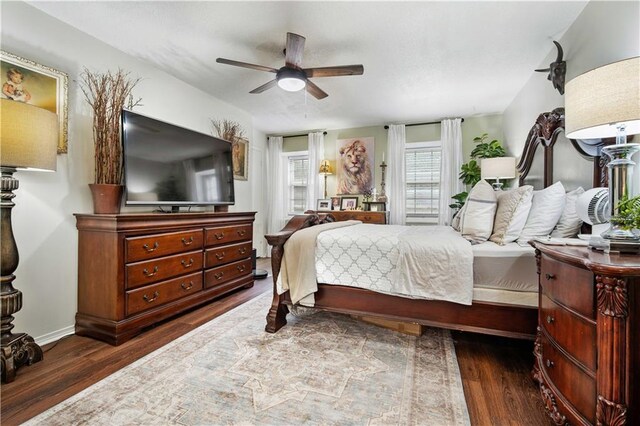 bedroom featuring ceiling fan and dark wood-type flooring