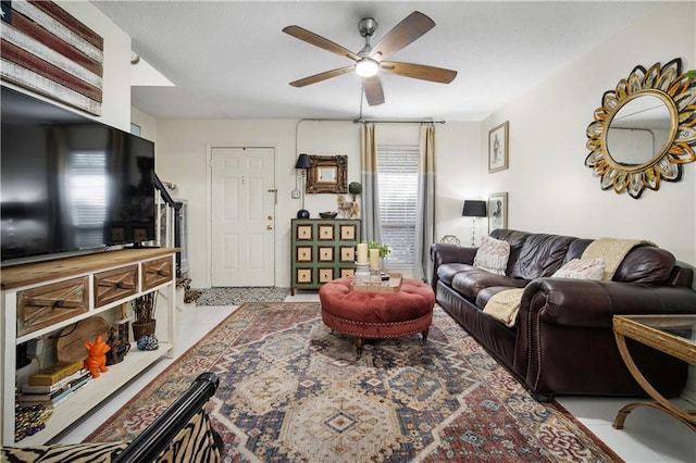 living room with ceiling fan and a wealth of natural light