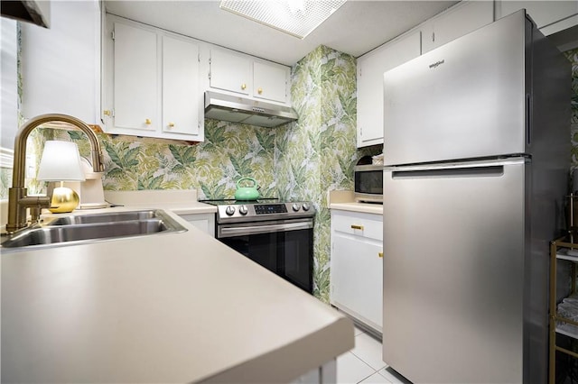 kitchen with white cabinets, light tile patterned flooring, sink, and stainless steel appliances