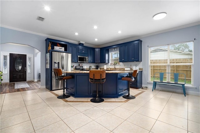 kitchen featuring blue cabinetry, light tile patterned flooring, visible vents, and appliances with stainless steel finishes