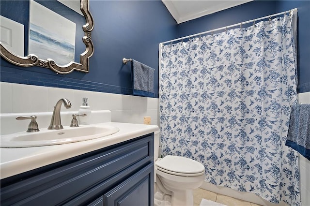 full bathroom with vanity, ornamental molding, tile patterned floors, toilet, and tile walls