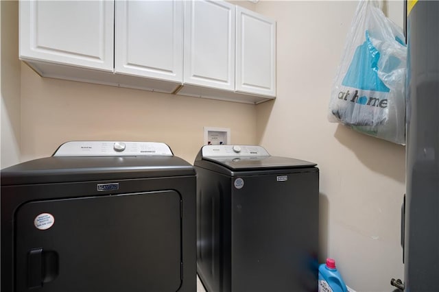 washroom featuring cabinet space and washing machine and dryer