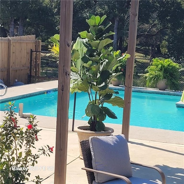 view of swimming pool with a fenced in pool and fence