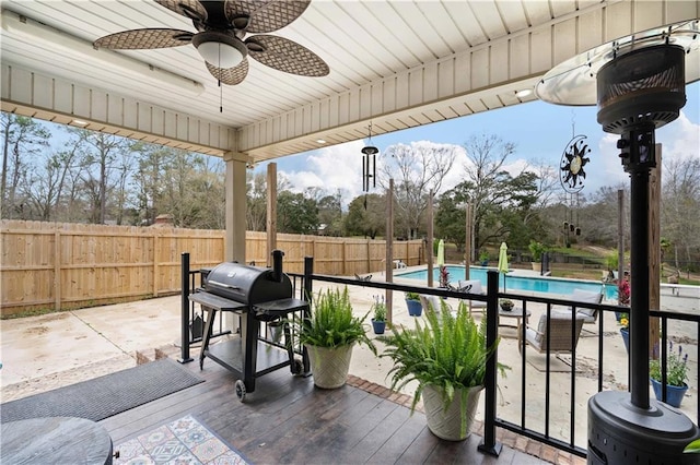 view of patio / terrace featuring ceiling fan, a fenced backyard, a fenced in pool, and a grill