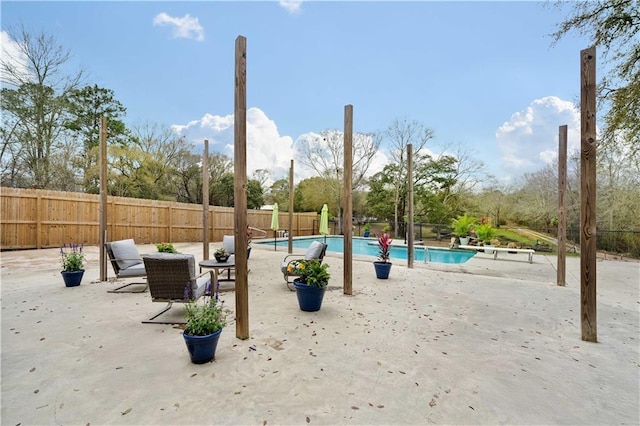 view of swimming pool with a patio, a fenced in pool, and a fenced backyard