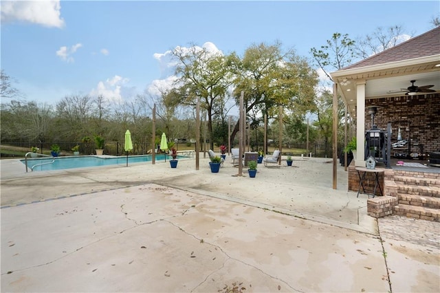 view of community featuring a pool and a patio area