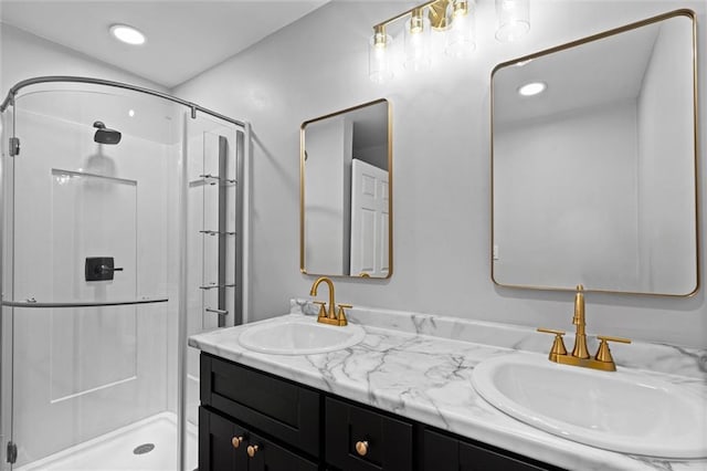 full bath featuring double vanity, a sink, recessed lighting, and a shower stall