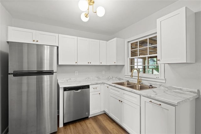 kitchen with a sink, white cabinetry, appliances with stainless steel finishes, and dark wood-style floors