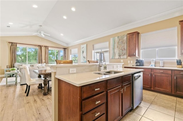 kitchen with open floor plan, light countertops, a sink, and dishwasher