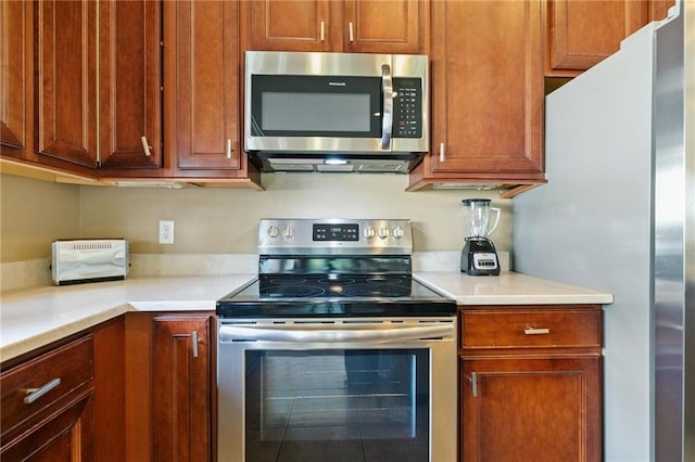 kitchen featuring stainless steel appliances and light countertops