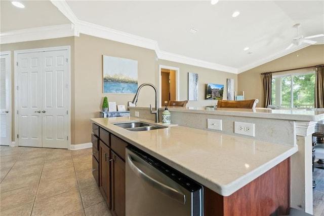 kitchen with light tile patterned floors, a center island with sink, dishwasher, lofted ceiling, and a sink