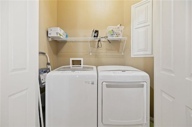 laundry area with cabinet space and washing machine and clothes dryer