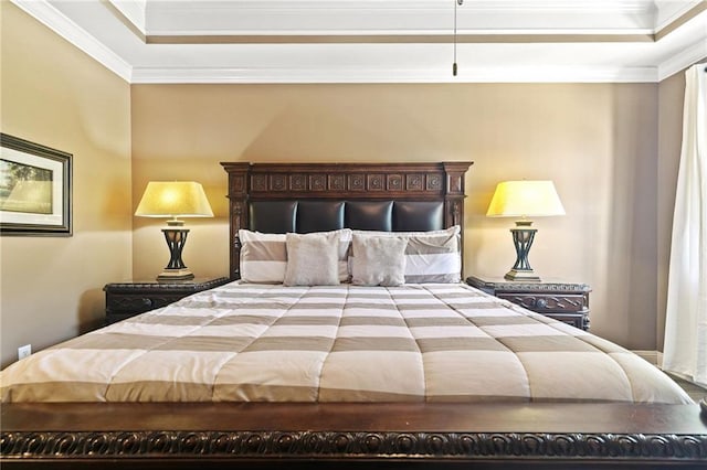 bedroom featuring a raised ceiling and crown molding