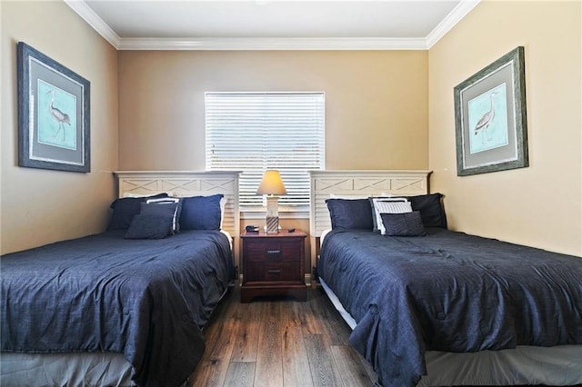 bedroom with ornamental molding and wood finished floors