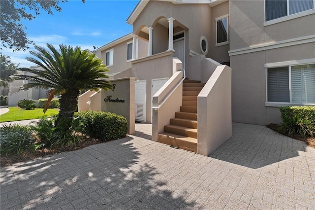 view of exterior entry featuring stucco siding