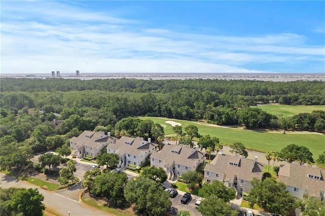 aerial view with golf course view and a view of trees