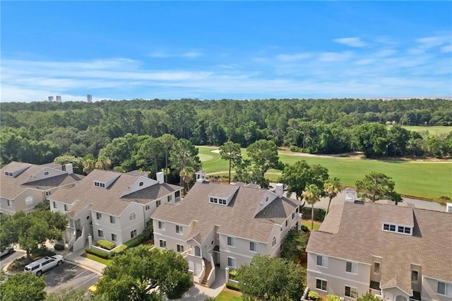 aerial view featuring a residential view, a forest view, and golf course view